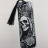 3D printed monochrome skull bookmark with tassel on white background