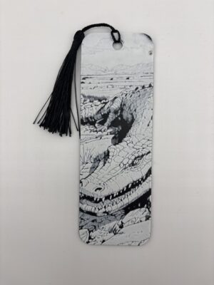3D printed monochrome crocodile bookmark with black tassel on white background