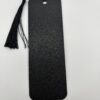 Back side of 3D printed PLA bookmark with textured black finish and decorative tassel