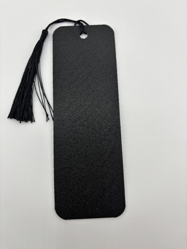 Back side of 3D printed PLA bookmark with textured black finish and decorative tassel