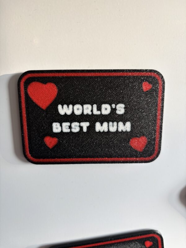 3D printed World’s Best Mum fridge magnet with red hearts and black background