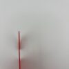 Thin side view of red 3D printed door hanger showing thickness