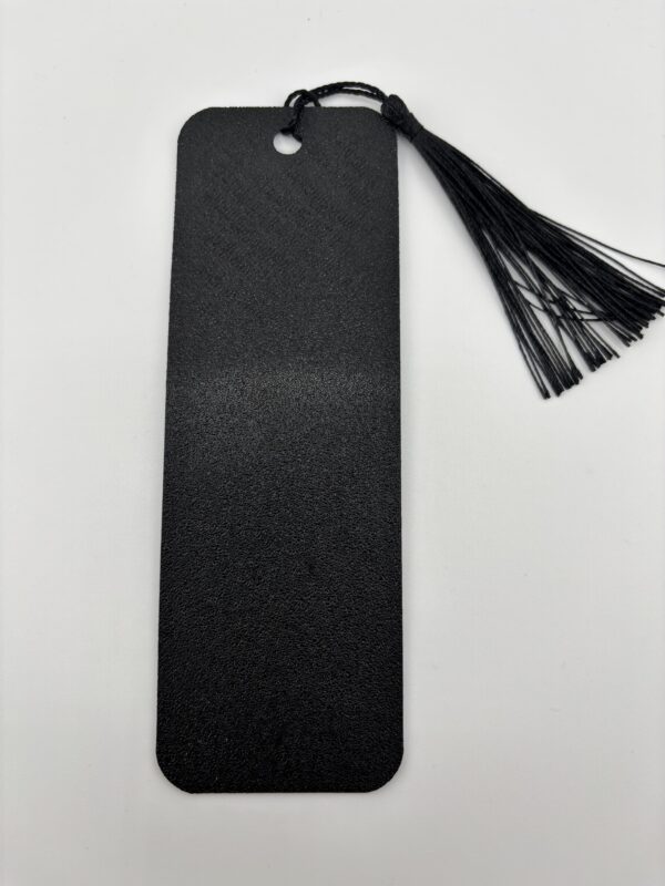 Back side of 3D printed PLA bookmark with textured black finish and decorative tassel