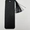 Back side of 3D printed PLA bookmark with textured black finish and attached tassel