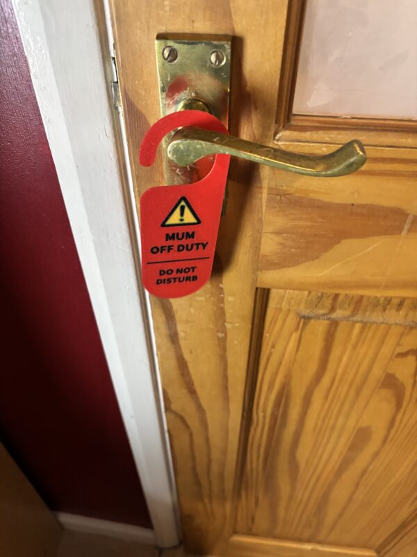 Mum off duty do not disturb door hanger hanging on a door handle